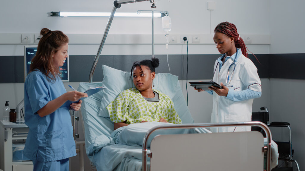 Multi ethnic team of specialists consulting young patient
