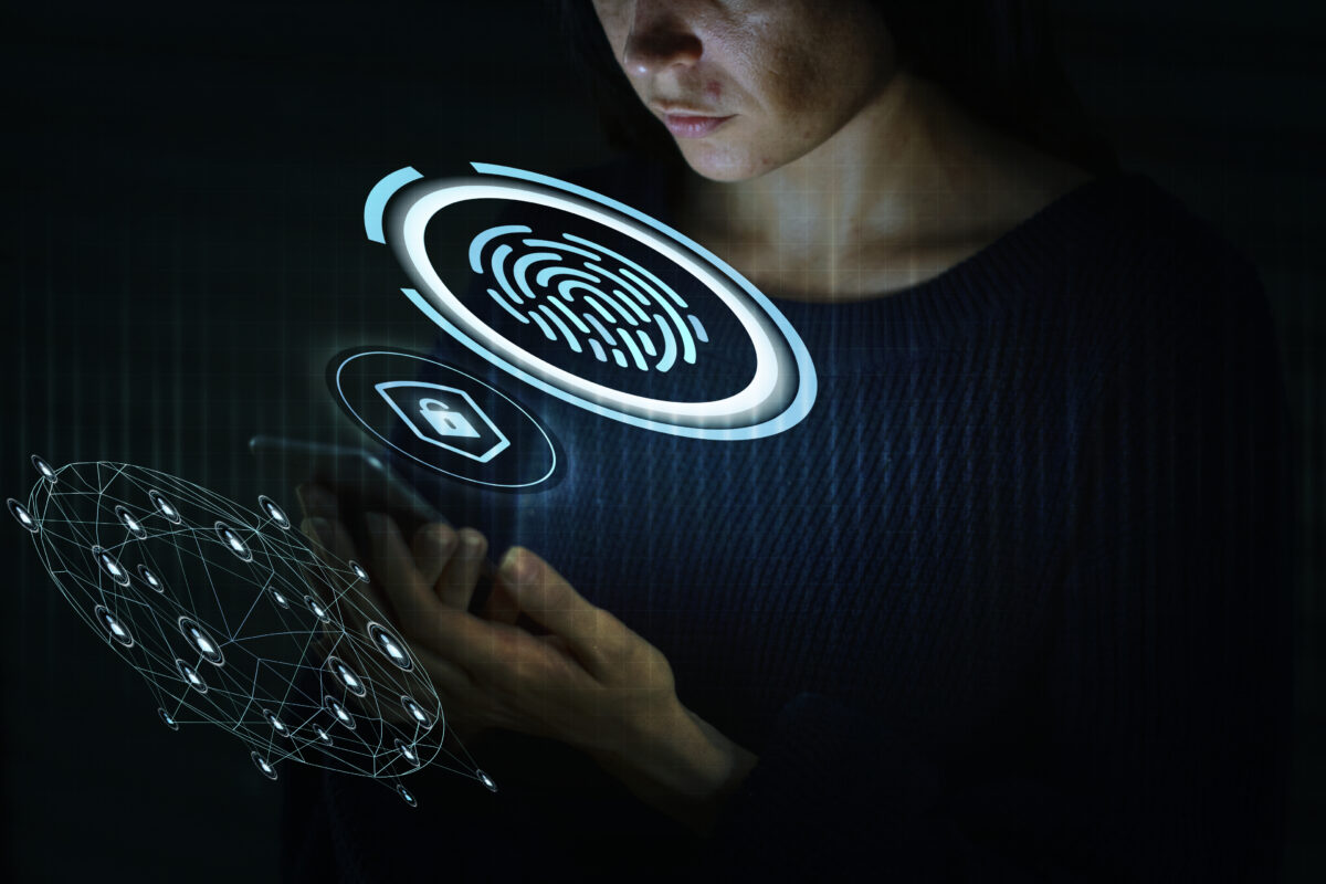Woman using a fingerprint scan to unlock her mobile phone